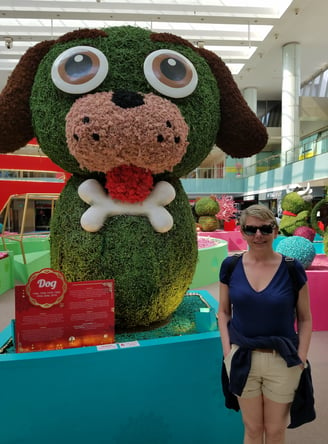 Lady poses with some local plant art at the mall at Pan Pacific Hotel in Singapore