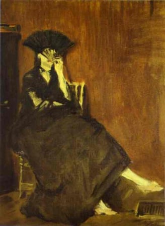 a woman in a black dress sitting on a chair