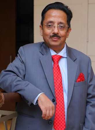 a man in a suit and tie with a red tie