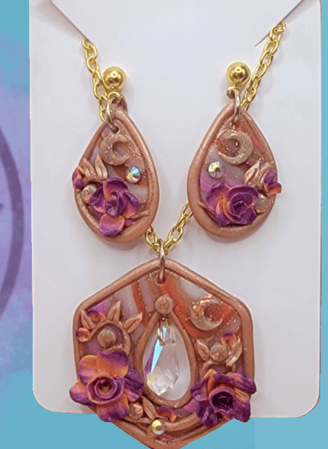 a collection of artisan jewelry with floral, gold, moon, gem, leaf, and geode accents.  