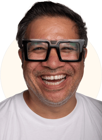 Tio Toto - smiling with black rim glasses and a white shirt