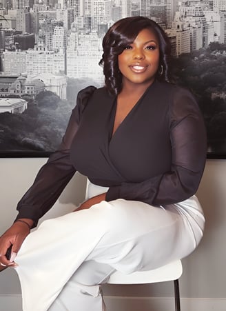 a woman in a black top and white pants