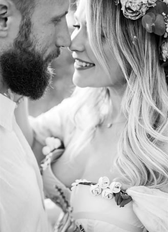 Close-up black and white portrait of couple — nose to nose, intimate fine art moment