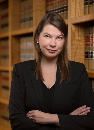 a woman in a suit and a suit jacket in a library