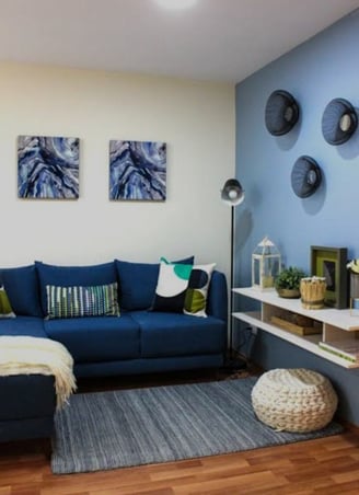 Interior de sala en departamento muestra general, CDMX. Sofá en tonos azules, decoración moderna