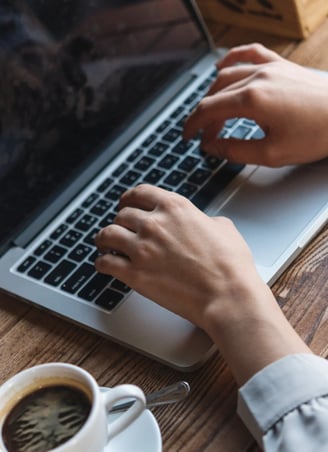 hands-working-with-laptop-representing-Pharmacovigilance-expert-support