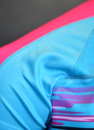 a close up of a blue and pink shirt with a pink and blue shirt