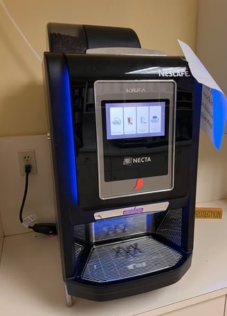 Nescafé Krea coffee vending machine with touchscreen interface.