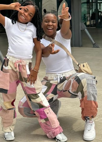 fronita and Abigail in matching clothes at the airport.