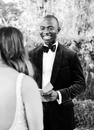 Black and white photo of groom reading vows during elopement ceremony in Provence