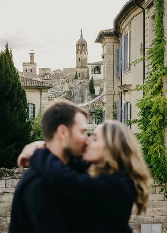 Artistic couple photo with blurred foreground — old stone architecture of Uzès, South of France