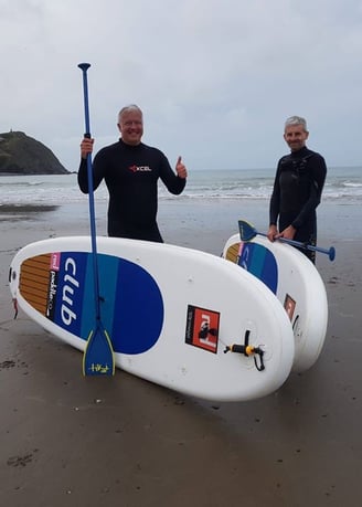 Derek the weatherman Brockway posing with paddle boards in Borth