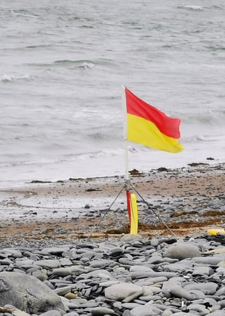 Lifeguard red and yellow patrol flag on the beach