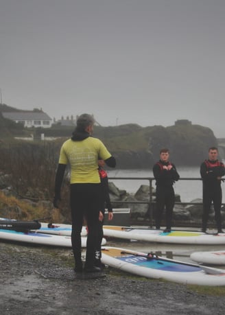 The rugby team getting intsruction from AberAdventures paddle board coaches