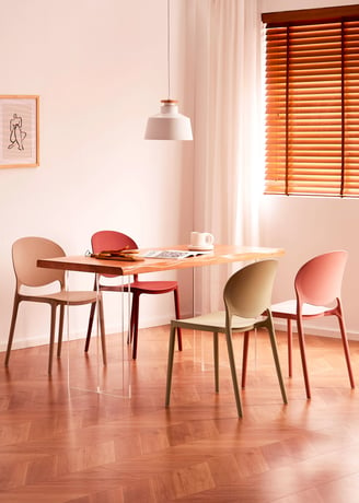 3D Renders of modern plastic chair set in a cozy, bright room with a wooden table, soft tones