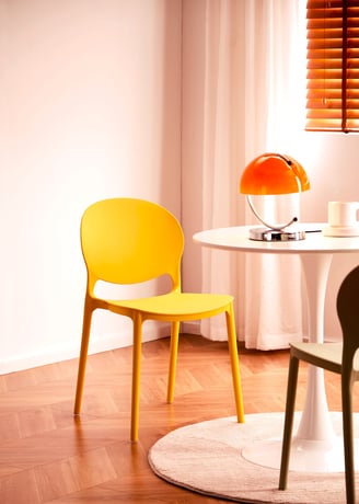 3D Renders of modern plastic chair set in a cozy, bright room with a wooden table, soft tones