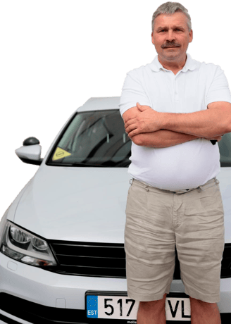 a man standing in front of a car with his arms crossed and his arms crossed