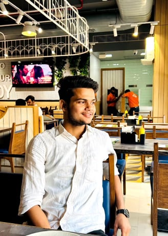 a man sitting at a table with a plate of food