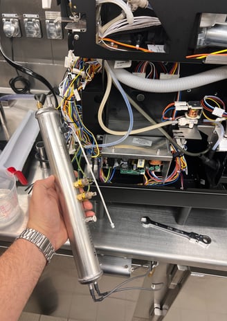 Steam boiler removed from espresso machine during technical service in South Florida