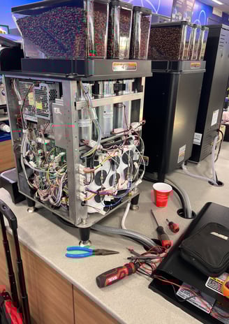 BUNN coffee machine with wiring and circuit boards exposed during repair.
