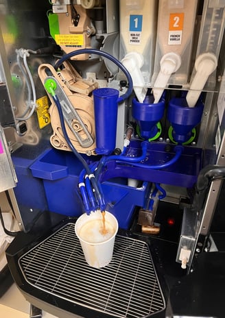 Nescafé Krea coffee machine showing dual grinder system and internal components.