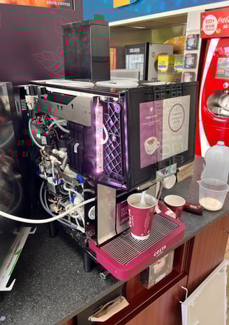 Costa Coffee self-service machine with panel open for internal inspection.