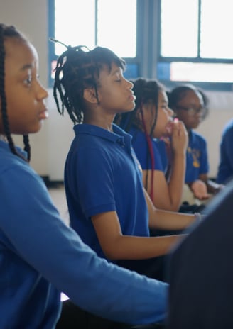 Students practicing deep breathing.