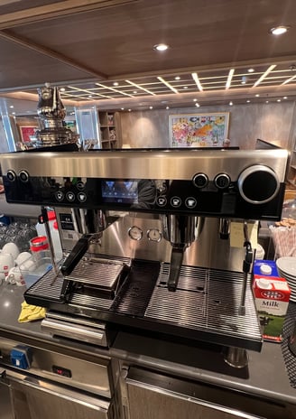 Schaerer Barista espresso machine in a luxury lounge setup with clean cups ready for service.