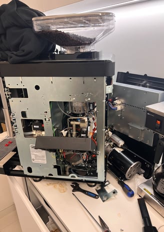 La Cimbali espresso machine undergoing internal service and inspection.