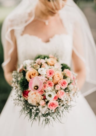 a bride in a wedding dress holding a bouquet