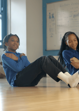 Students doing an abdominal exercise.