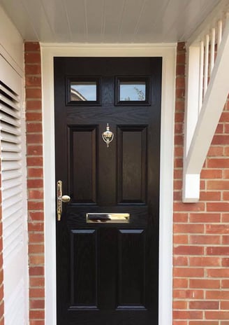 A black 4 panel 2 square door on ref bricks in black fitted in Gosport by Buildmydoor