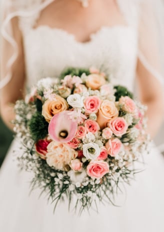 a bride in a wedding dress holding a bouquet