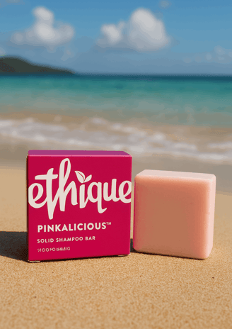 A shampoo bar from Ethique, the Pinkalicious version, sitting on the shore of a Thai beach