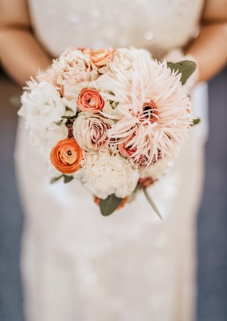 a bridesmael holding a bouquet of flowers
