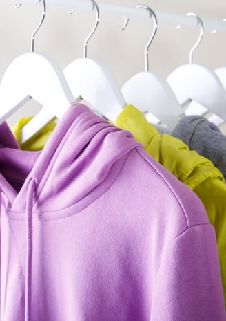 a bunch of clothes hanging on a rack