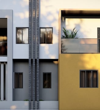 a yellow and white building with two balconies