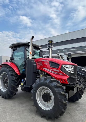 a red tractor with a large wheel on it