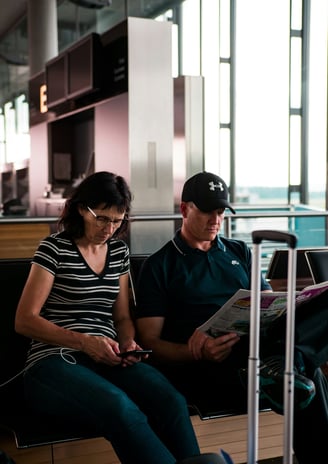 Women looking at phone in airport