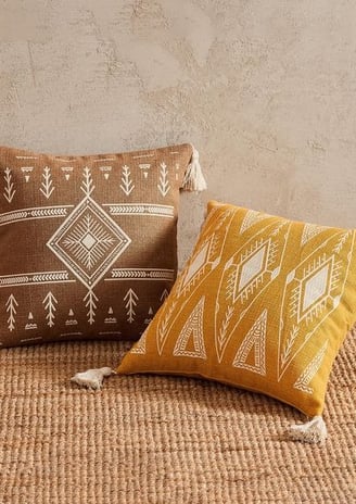 a pair of pillows with a brown and white pillow