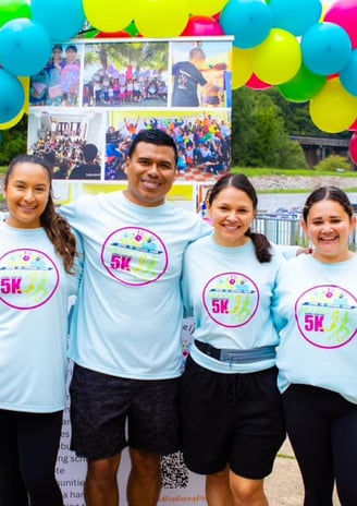 a group of people standing in front of a sign