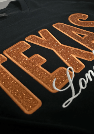 Custom black sweatshirt with glitter TEXAS appliqué and white script embroidery – personalized hoodi