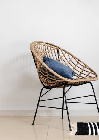 a chair with a cushion and a chair with a rug