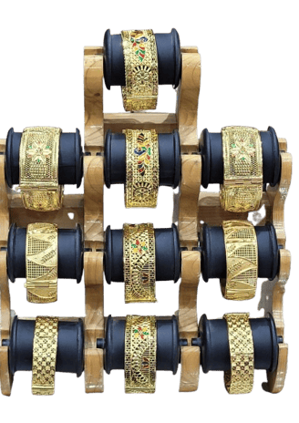 a display of gold and black bracelets with gold and black and white bracelets