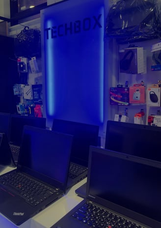 a row of laptops with a blue light on the wall