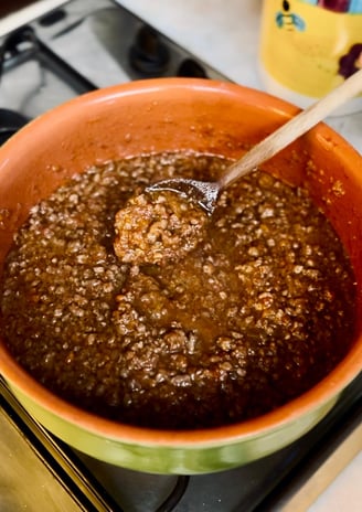 Alessandra Spisni cooking ragù Bolognese, a classic recipe from Emilia-Romagna cuisine.