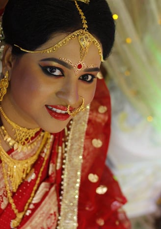 a woman in a red dress and gold jewelry