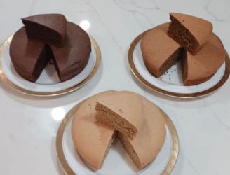 Gluten free cakes by Only Oats with a slice cut from each in chocolate and vanilla.