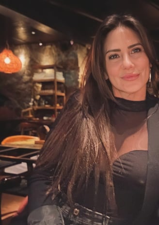 a woman in a black dress and a black jacket