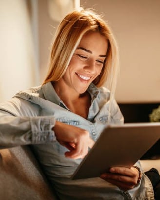 a woman sitting on a couch with a laptop